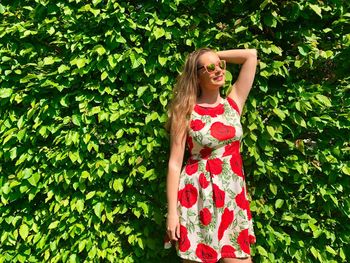 Woman standing against plants