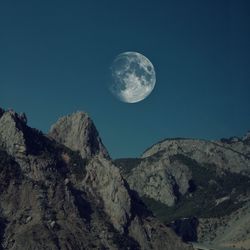 Low angle view of moon against sky at night