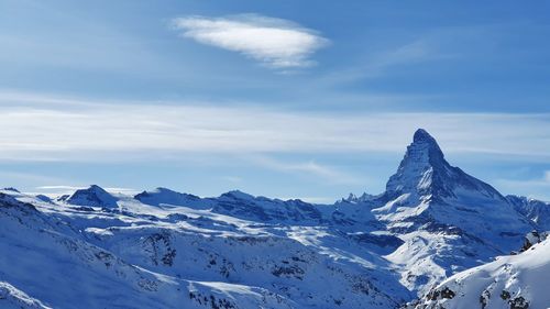 Scenic view of snowcapped mountains against sky