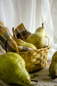 Close-up of pears in basket on table