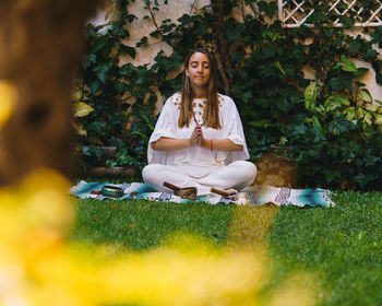 Portrait of young woman sitting outdoors