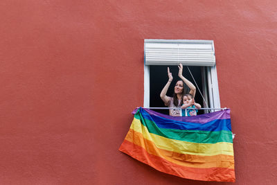 Portrait of woman standing against wall