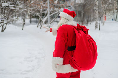 Red umbrella on snow covered field