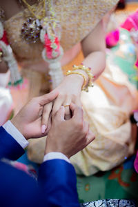 Midsection of couple holding hands