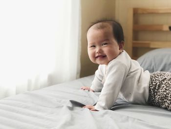 Portrait of boy on bed at home