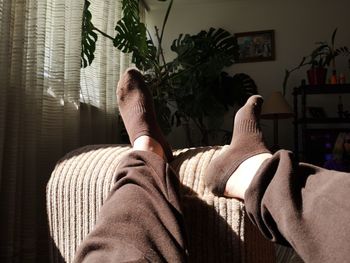 Low section of man relaxing at home