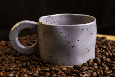 Close-up of roasted coffee beans on table