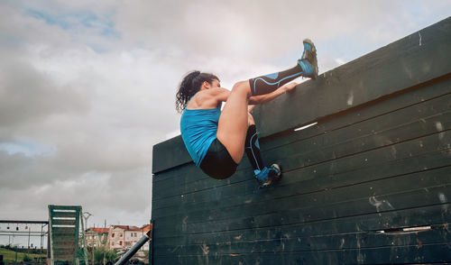 Low angle view of woman against sky