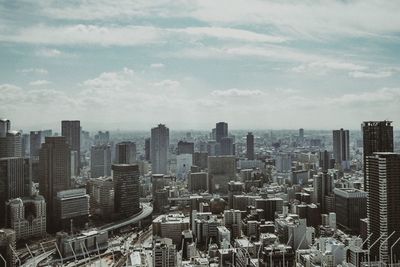 Aerial view of modern buildings in city against sky