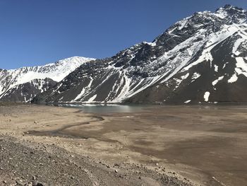 Scenic view of snowcapped mountains against clear sky