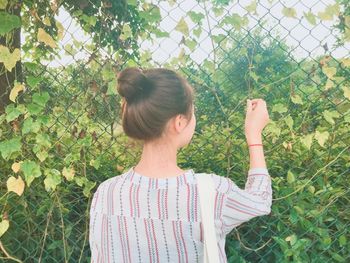 Rear view of girl standing by plants