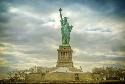 Low angle view of statue against cloudy sky