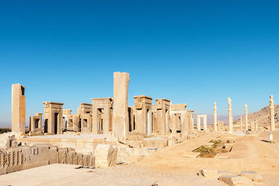 Ruins of ancient temple against clear blue sky