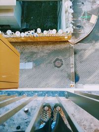 High angle view of wet glass container on railroad tracks