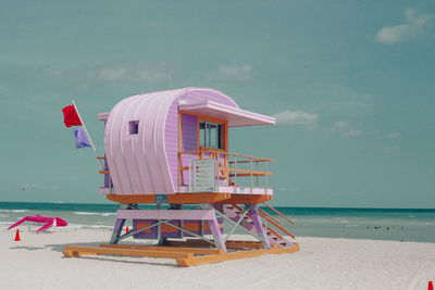 Lifeguard hut on beach against sky