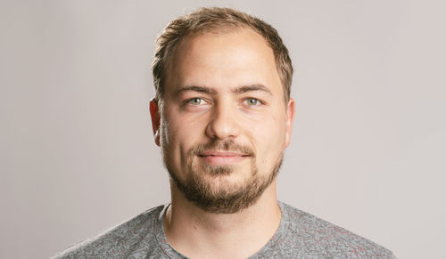 Portrait of young man against white background