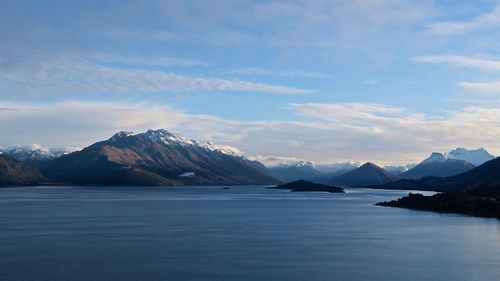 Scenic view of lake against mountains during sunset