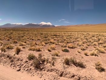 Scenic view of arid landscape against sky