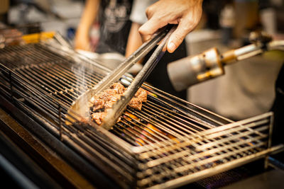 Man preparing food on barbecue grill