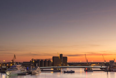 Boats in sea against sky during sunset