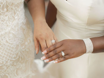 Midsection of couple holding hands