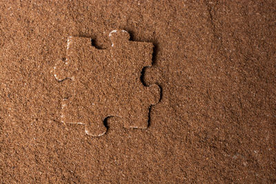 Close-up of heart shape on sand