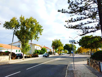 View of street against cloudy sky