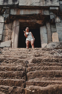 Full length of woman standing against building