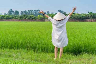 Rear view of man standing on field