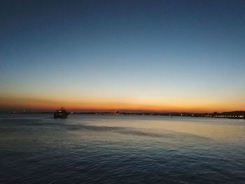 Scenic view of sea against clear sky during sunset