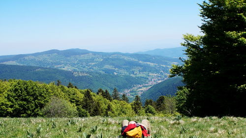 Rear view of people on mountain road against sky