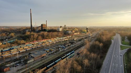 High angle view of vehicles on road in city against sky