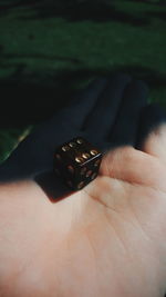 Close-up of dice on human palm