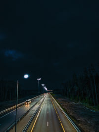 Highway against sky at night