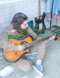 Portrait of woman playing guitar