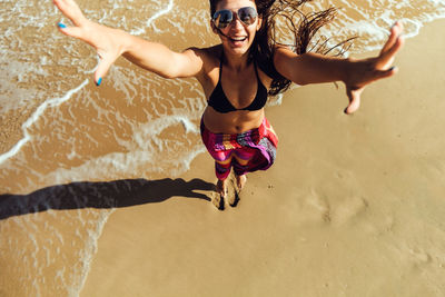 Young woman wearing sunglasses on beach