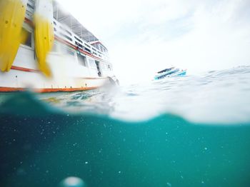 Boat sailing in sea against sky