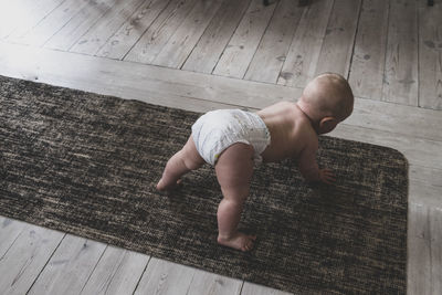 High angle view of baby crawling