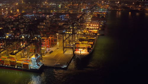 High angle view of illuminated commercial sea port at night