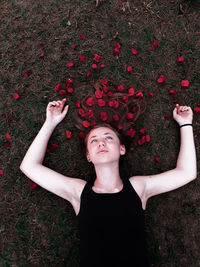 High angle view of woman lying down on field