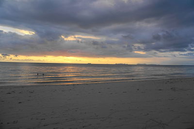 Scenic view of beach against sky during sunset