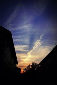 Low angle view of buildings against sky at sunset