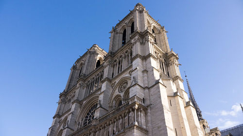 Low angle view of bell tower against blue sky