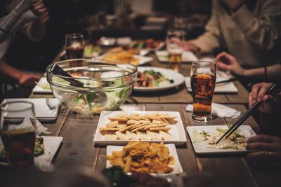 Friends having food at table in restaurant