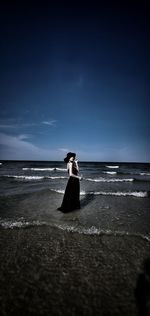 Woman on beach against sky