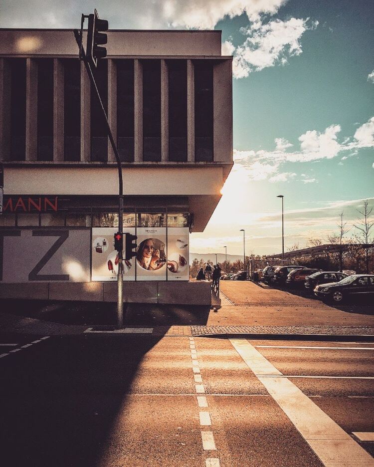 REFLECTION OF WOMAN ON ROAD IN CITY