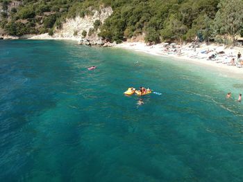 High angle view of people enjoying in sea