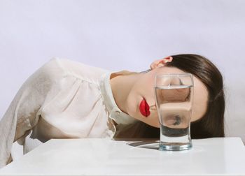 Young woman in front of drink on table