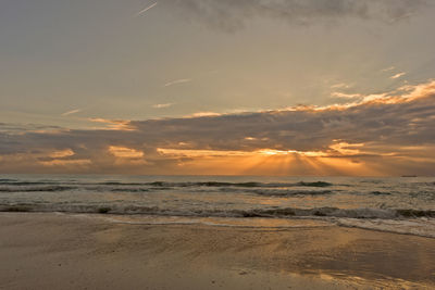 Scenic view of beach against sky during sunset