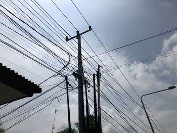 Low angle view of electricity pylon against sky